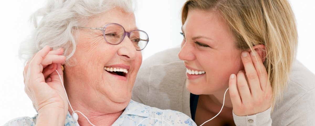 Excited grandmother listening music together with her granddaugh